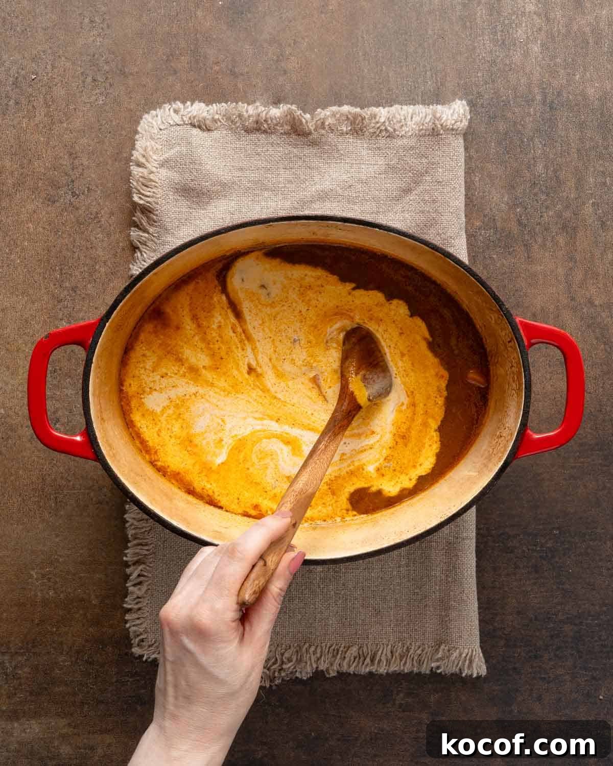 heavy cream being stirred into soup.