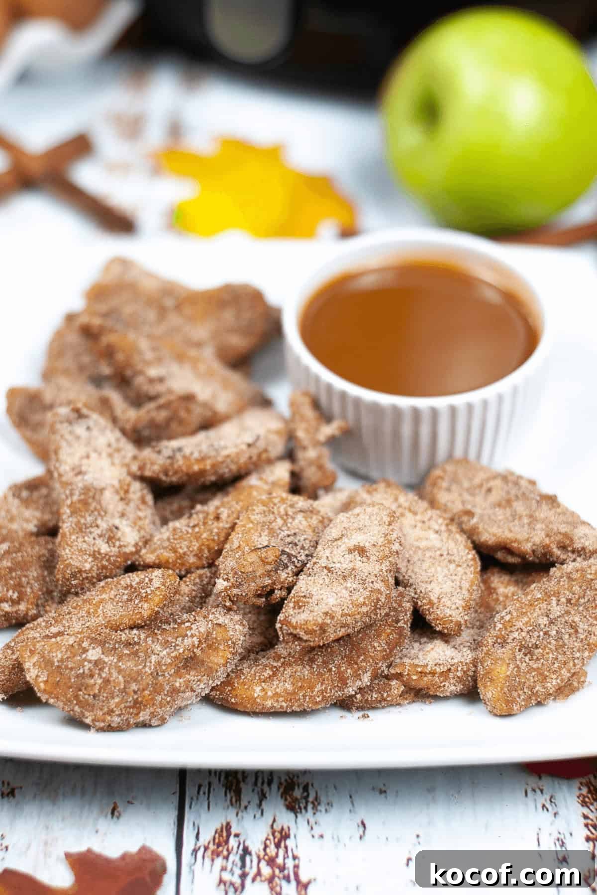 Crispy Pumpkin Spice Air‑Fried Apple Slices for Fall Snacks 3 A tray of the dessert with caramel sauce.