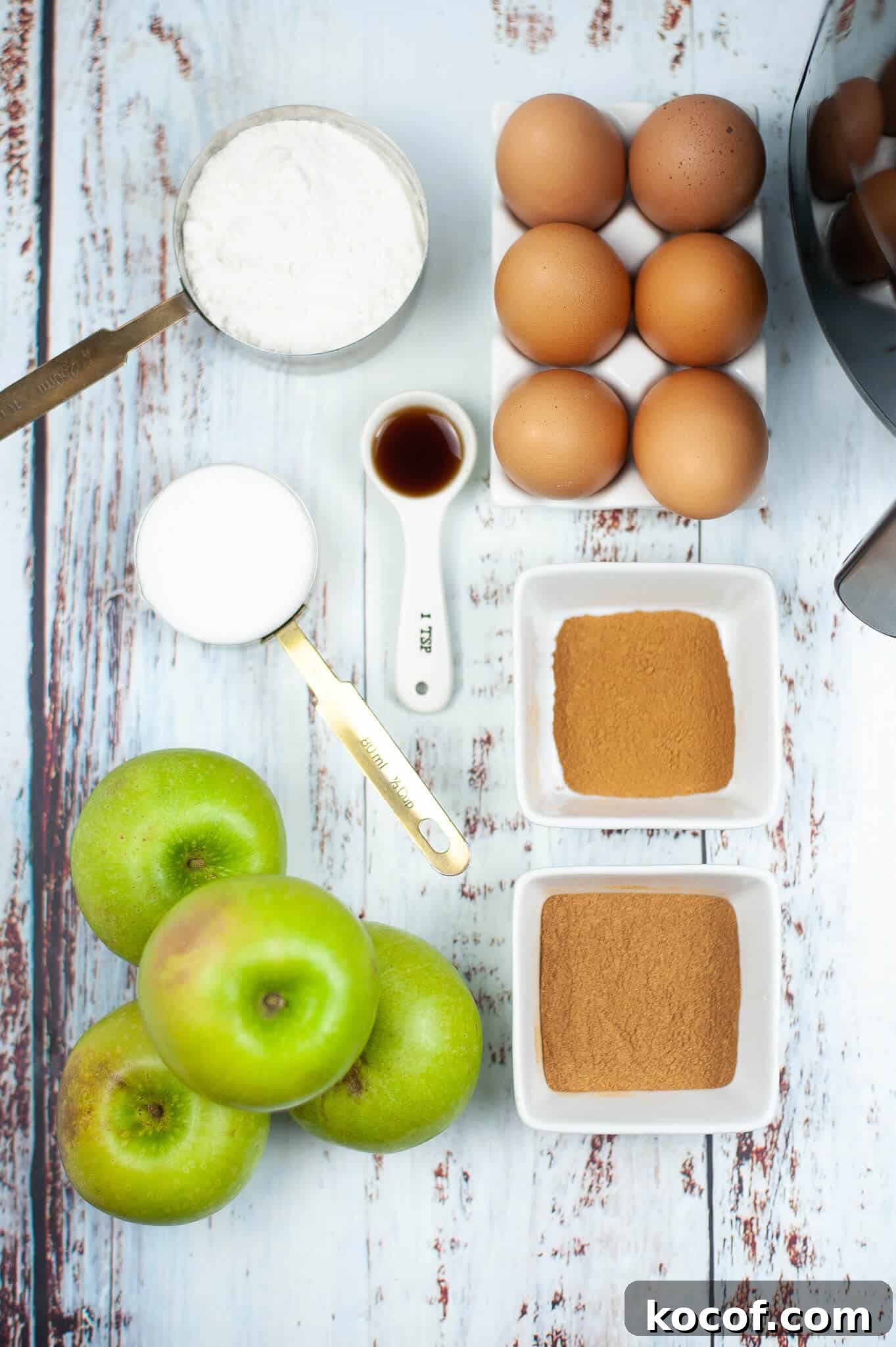 Crispy Pumpkin Spice Air‑Fried Apple Slices for Fall Snacks 4 Ingredients on a table: green apples, flour, eggs, cinnamon, sugar, vanilla extract, and milk—perfect for creating a cozy treat or air fried apples delight.