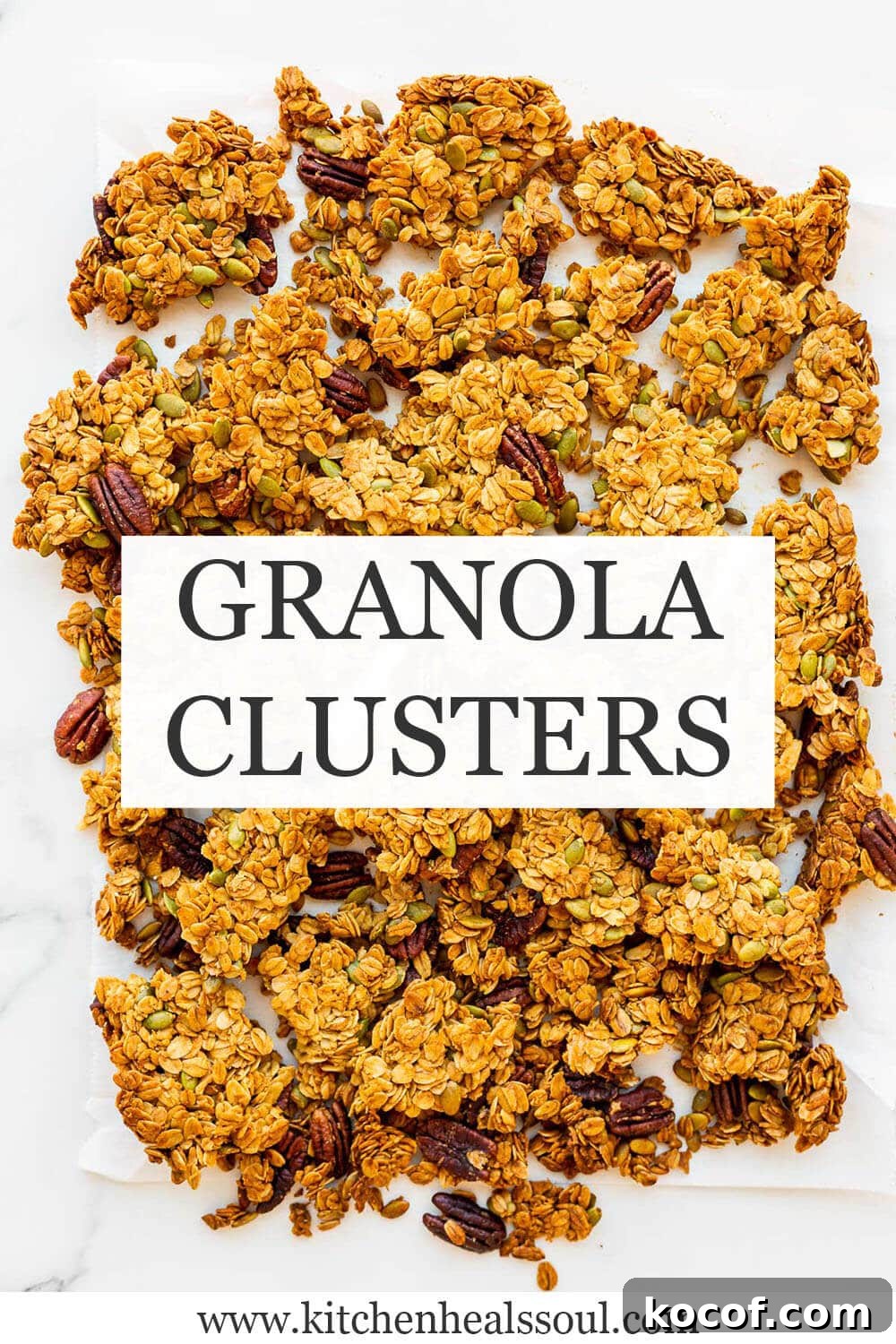 Homemade granola clusters broken into big pieces on parchment paper