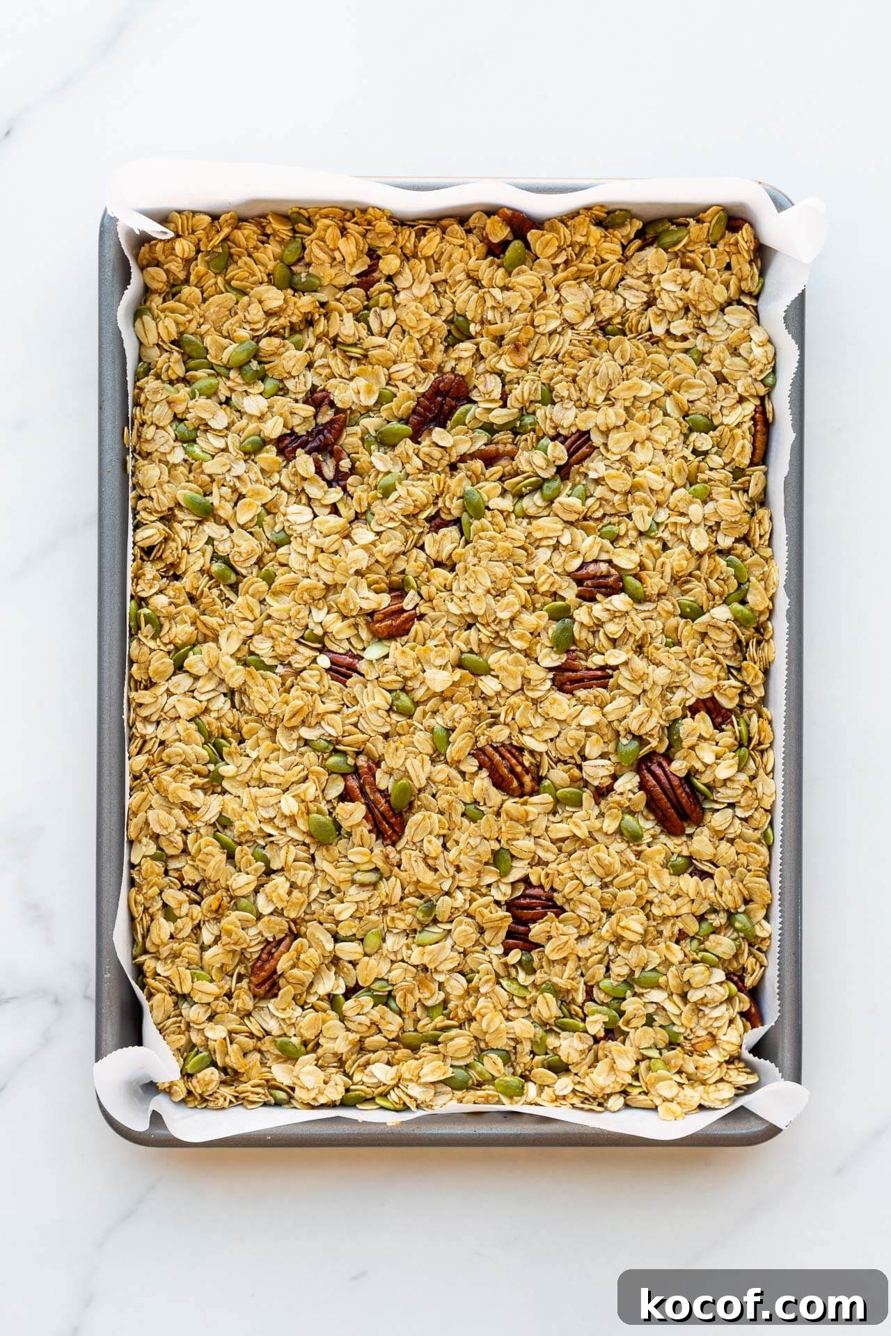 Granola mixture pressed in a sheet pan