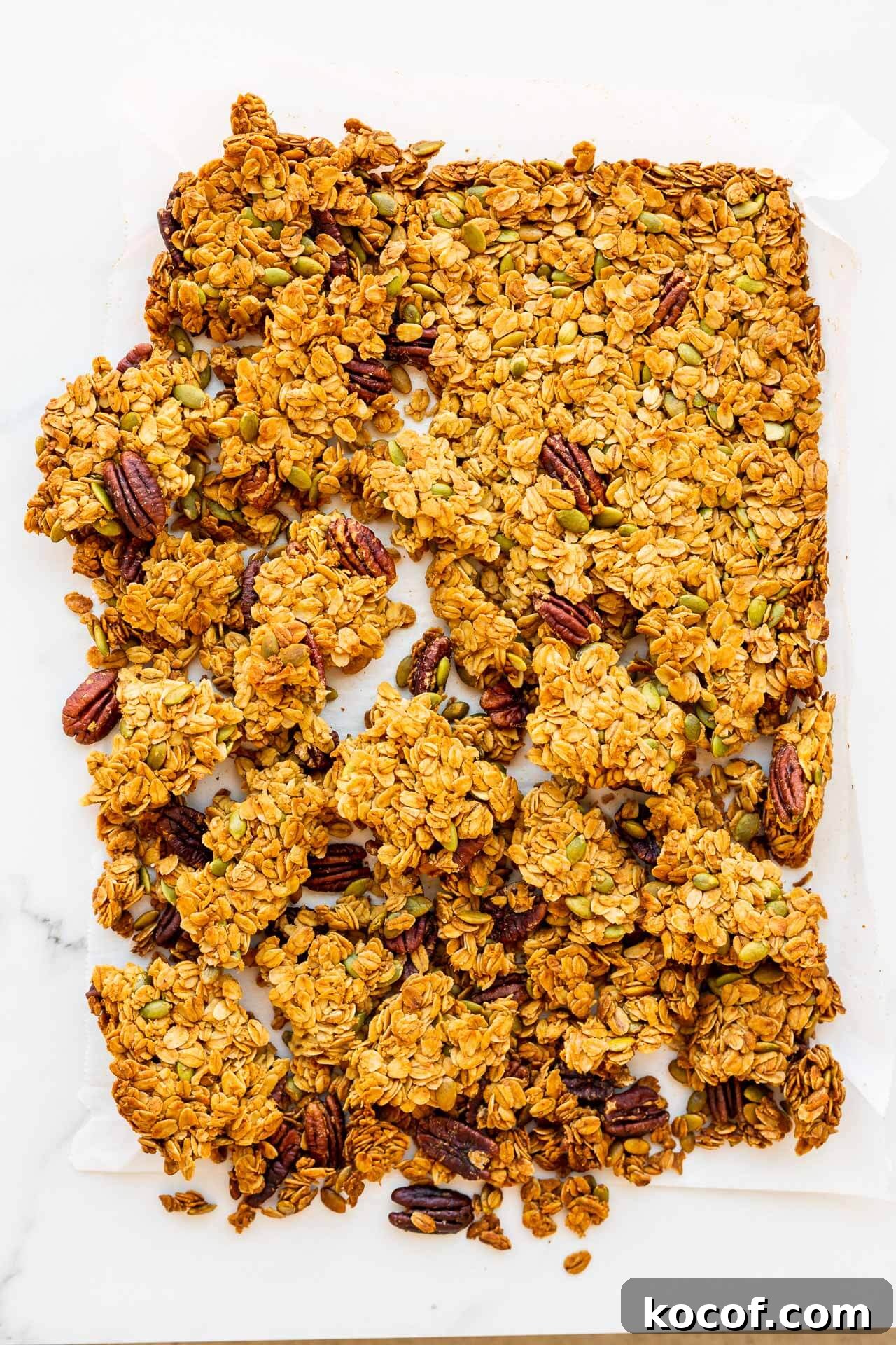 Breaking a sheet of granola into clusters