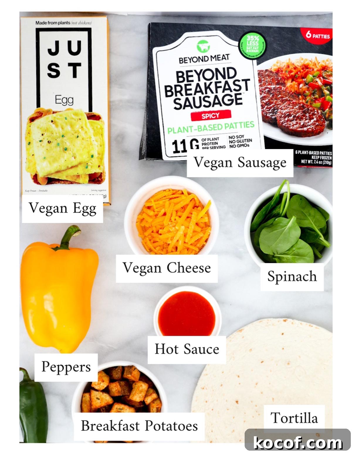 Labeled ingredients including: Just egg, vegan breakfast sausage, peppers, vegan cheese, spinach, hot sauce, tortillas, and breakfast potatoes
