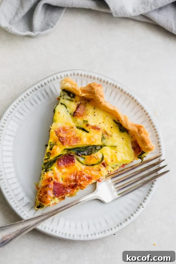 Perfect Breakfast Quiche A slice of breakfast quiche on a plate.