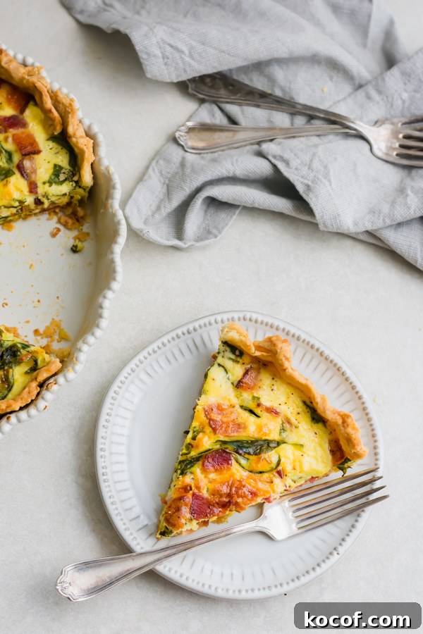 Quiche slice A slice of breakfast quiche on a plate.