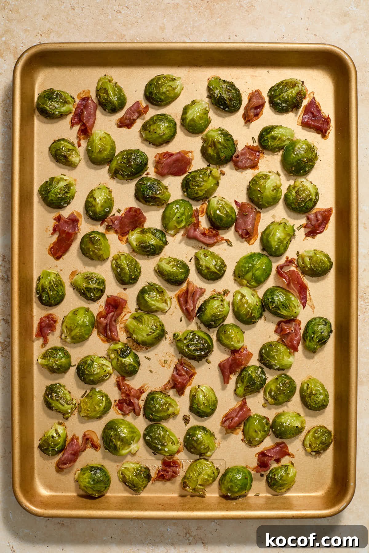 Roasted Brussels sprouts and crispy prosciutto on a sheet pan.