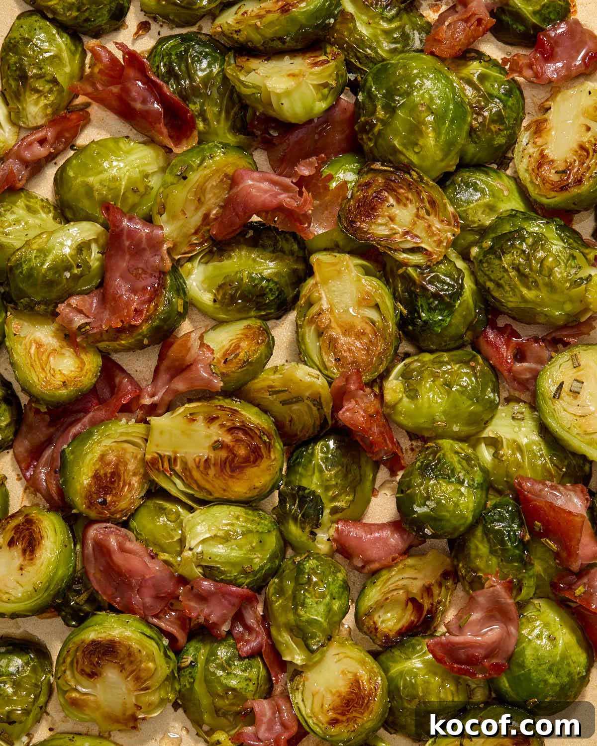 Roasted Brussels sprouts and prosciutto tossed with maple syrup.