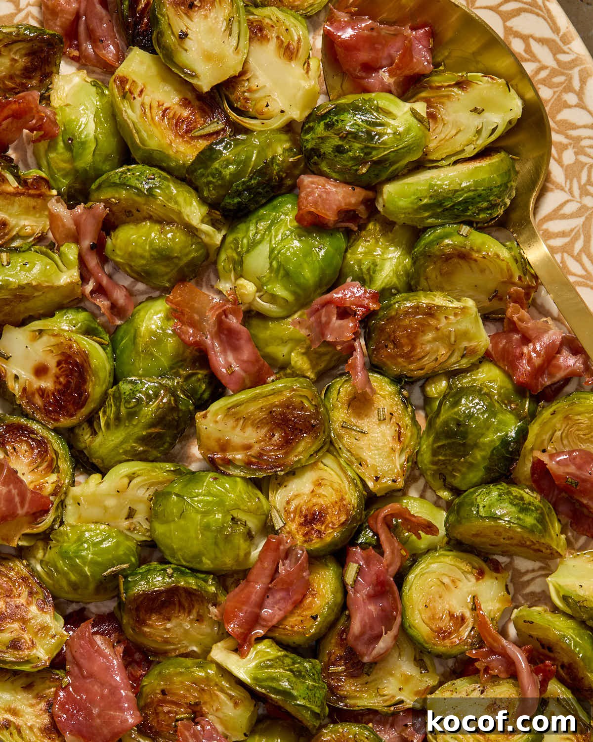 Close up of Brussels sprouts and crispy prosciutto on a platter.