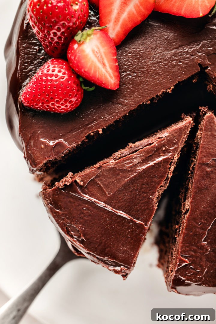 slicing a chocolate ganache filled cake