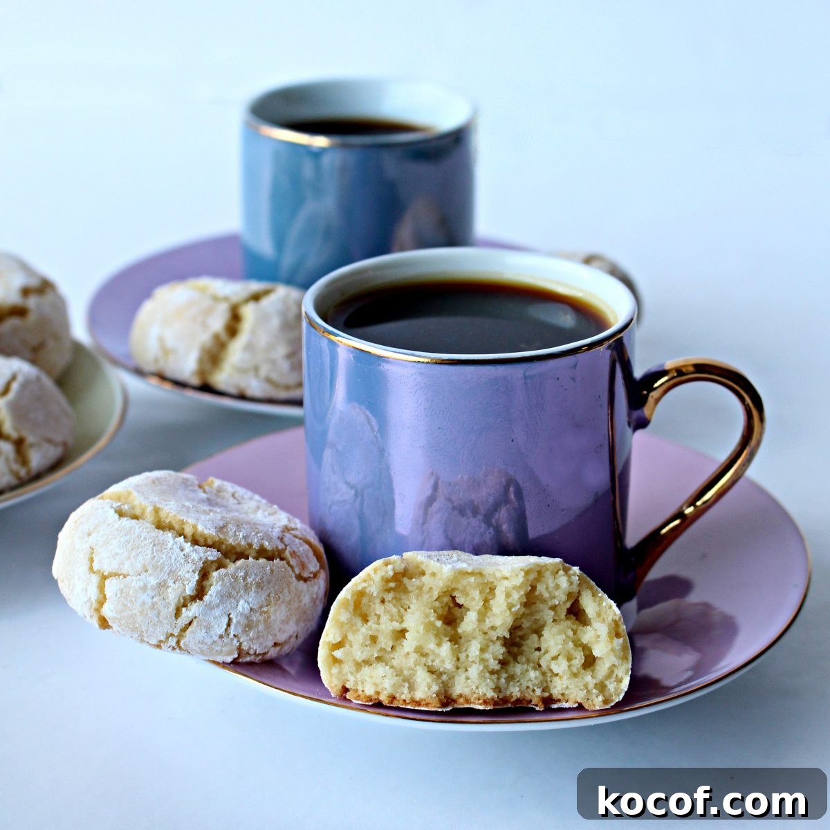 Cookies on saucer of a coffee cup showing thick, fluffy interior of one cookie.
