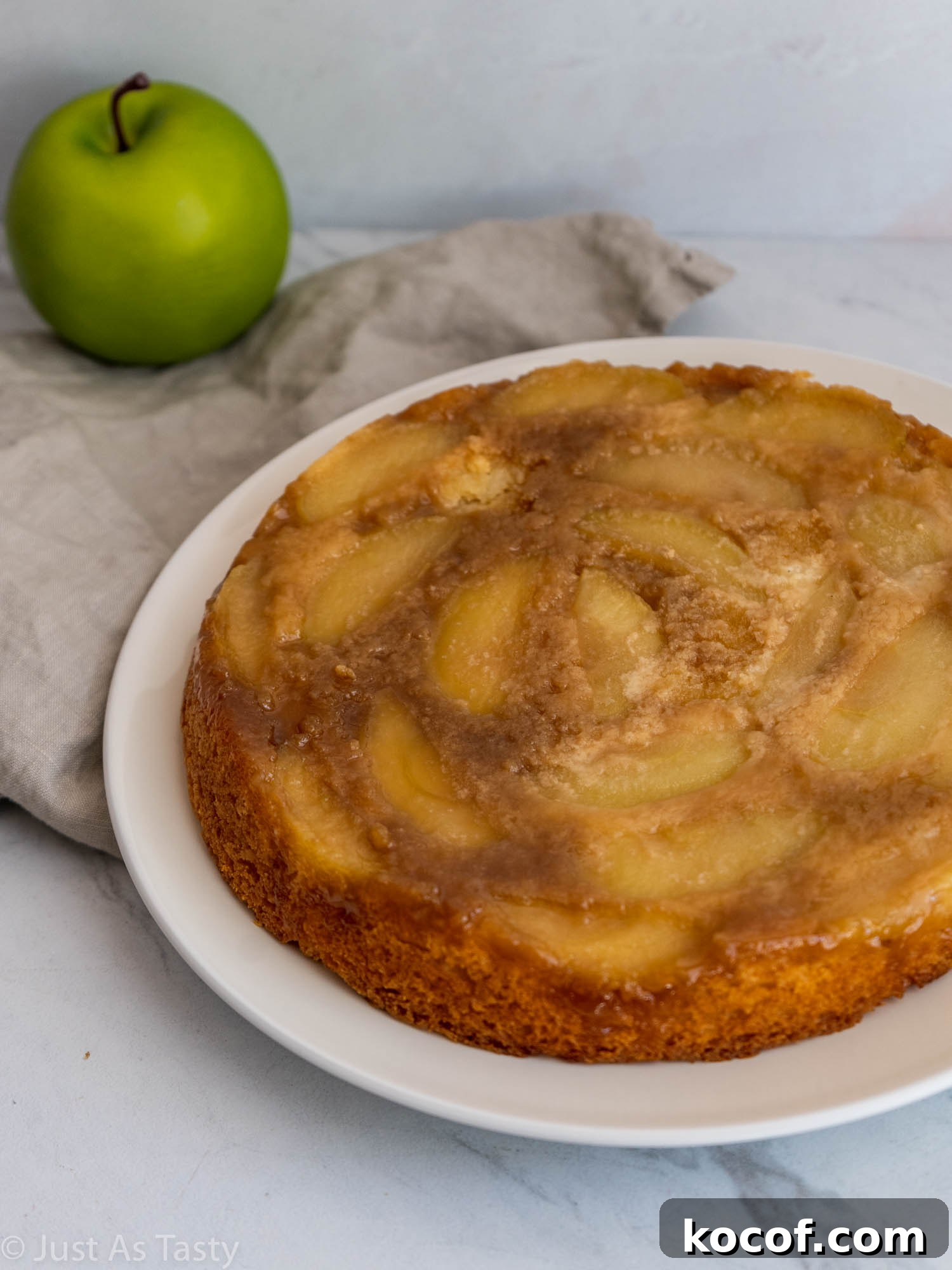 Gluten free single-layer apple cake on a white plate.