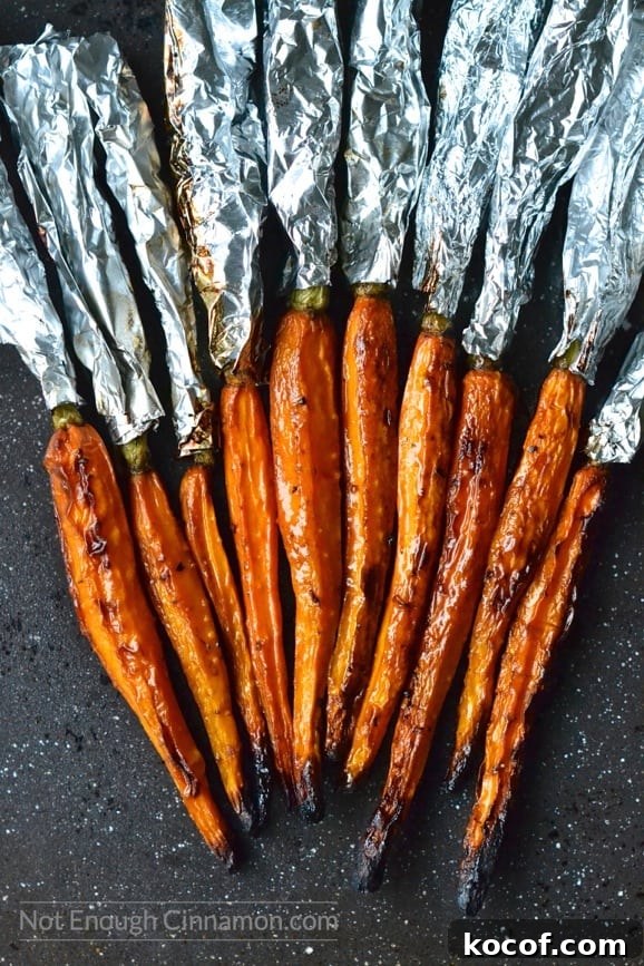 Balsamic-Glazed Roasted Carrots with Honey and Herbs 4 balsamic roasted carrots fresh out of the oven with aluminum foil still wrapped around the greens
