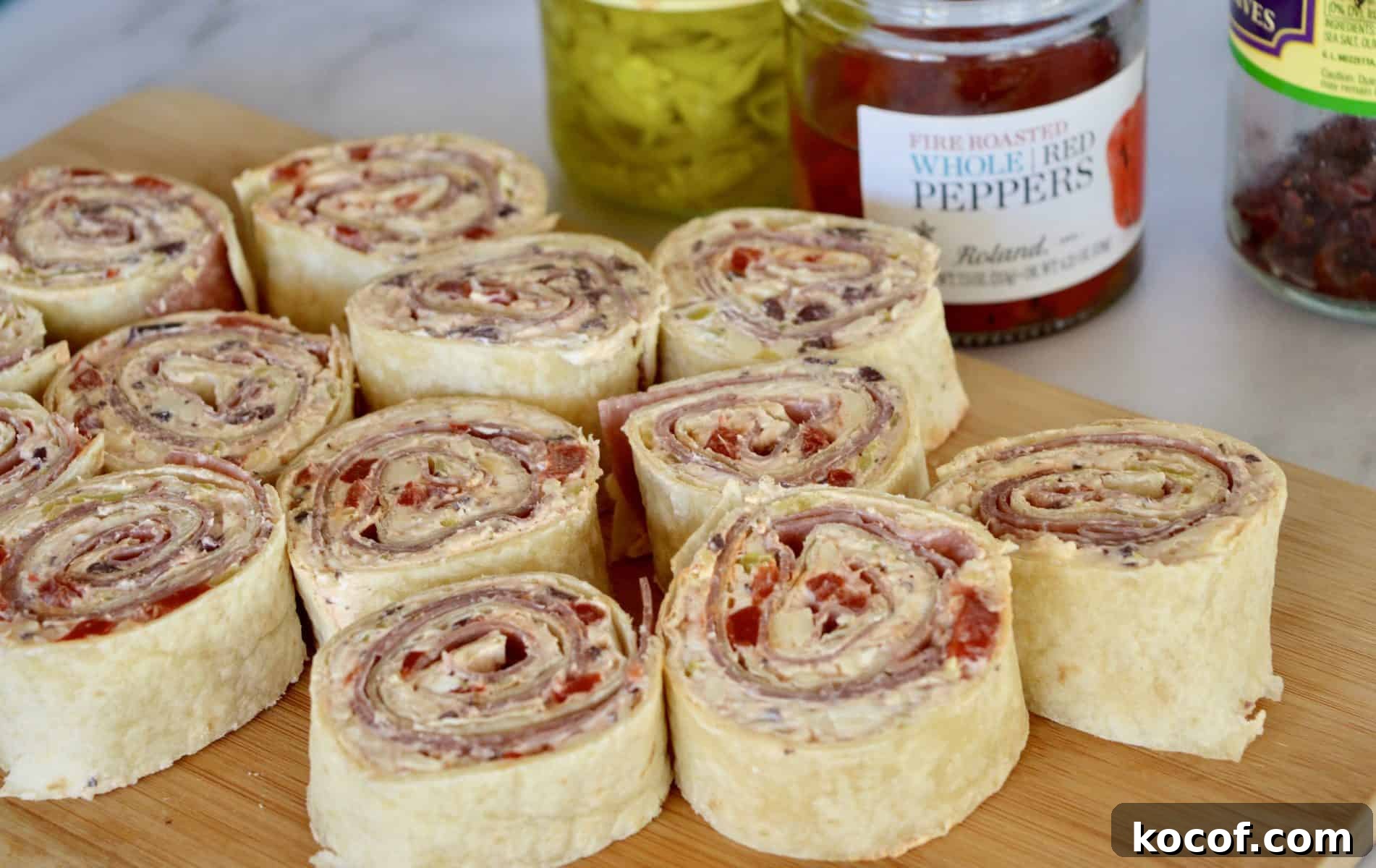 Italian Antipasto Pinwheels on a wood cutting board.