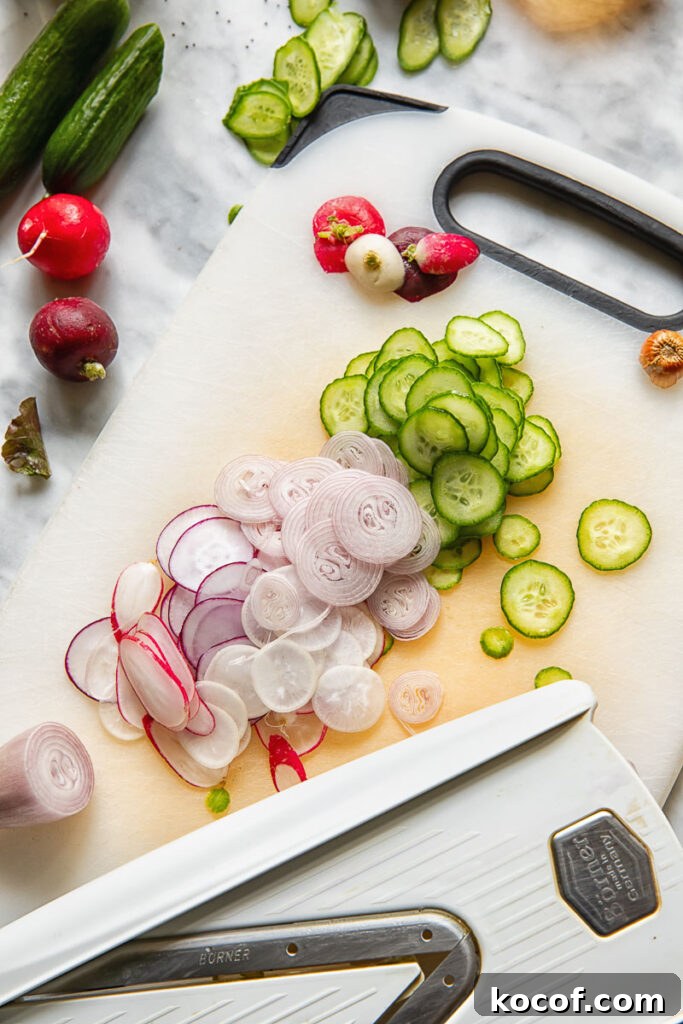 Fresh Garden Salad Recipe: Crisp Mixed Greens & Simple Dressing 5 Process shot onion radish and cucumber sliced with a mandolin