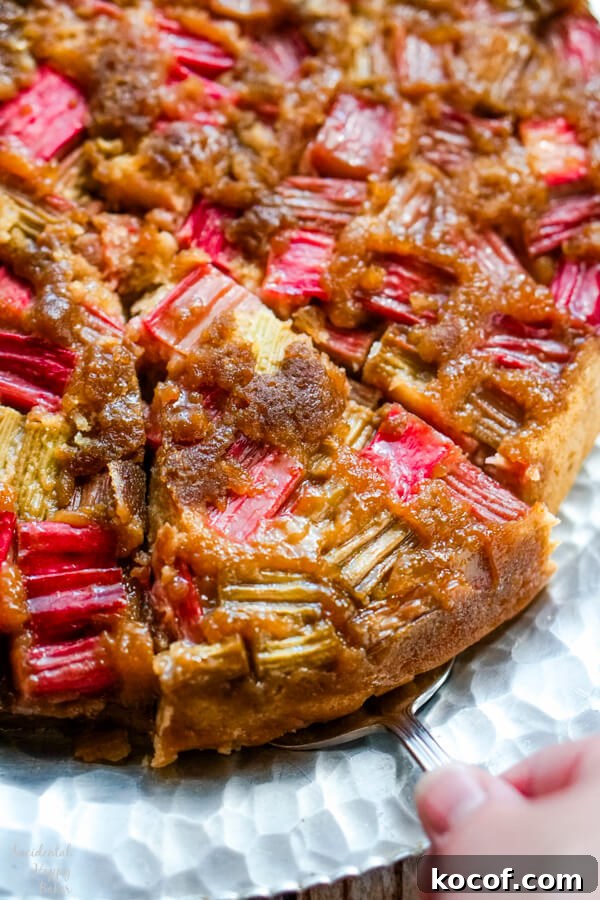 Rhubarb and Ginger Upside-Down Cake Recipe 2 A slice of rhubarb ginger upside down cake being served.