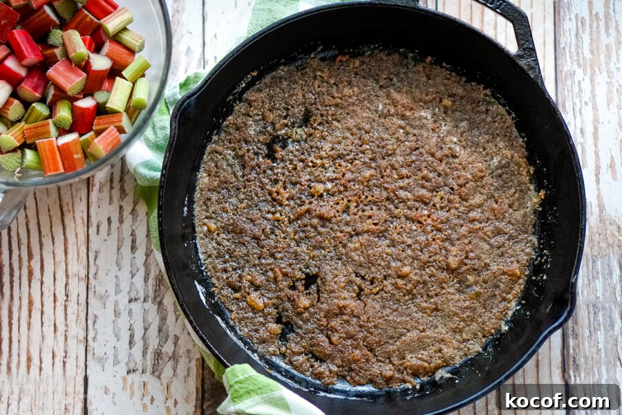 Rhubarb and Ginger Upside-Down Cake Recipe 4 A cast iron skillet with melted butter, ginger and brown sugar.