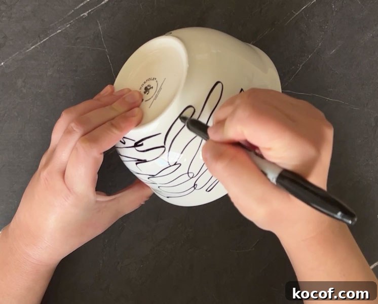 Create a Faux Marble Bowl: Step-by-Step DIY Tutorial 3 Hand scribbling on white bowl with black sharpie marker