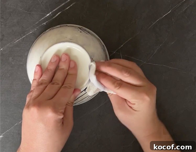 Create a Faux Marble Bowl: Step-by-Step DIY Tutorial 4 Hand botting surface of bowl with paper towel