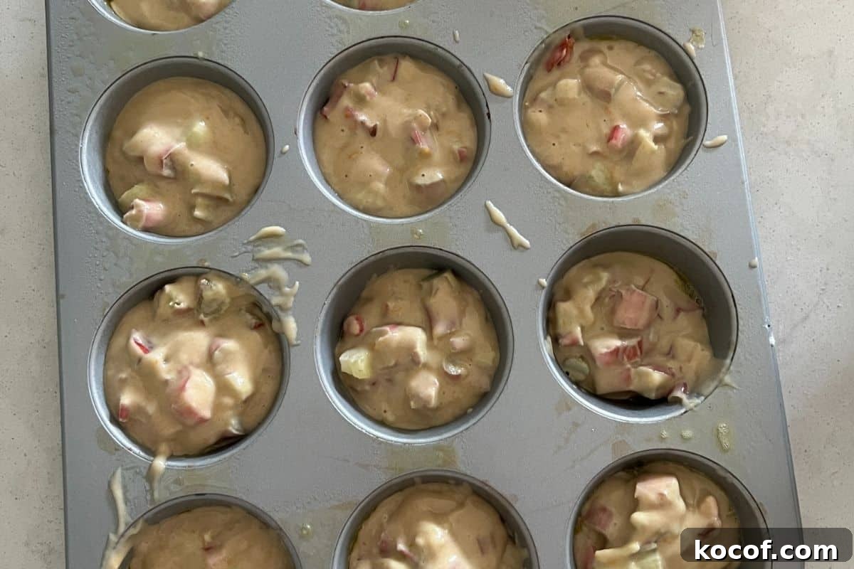 Buttermilk Orange Rhubarb Muffins — Tangy Spring Treats 6 Muffin batter in cupcake pan.