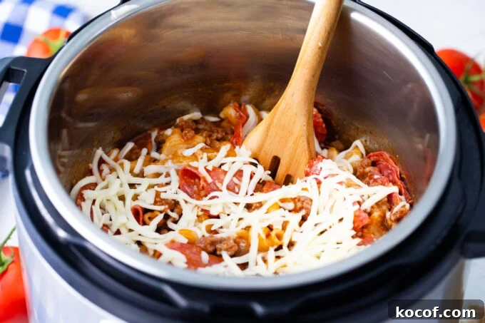 Adding cheese to instant pot pizza pasta.