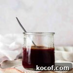 Creamy Vegan Caramel Sauce Recipe for Desserts and Toppings 7 Vegan caramel sauce in a glass jar with a spoon in it.