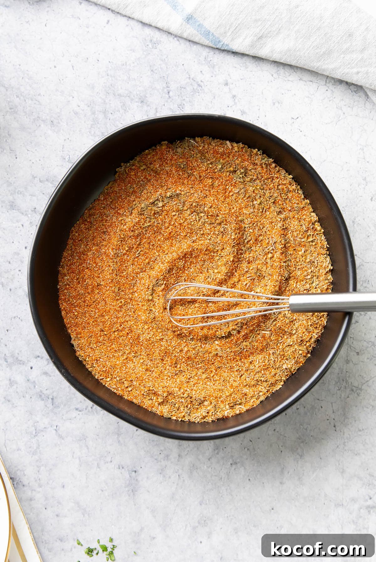 Spices completely well mixed together in a spice bowl with a spoon