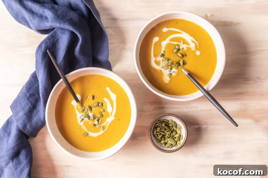 Creamy Butternut Squash and Carrot Soup Recipe for Fall 2 2 bowls of butternut squash and carrot soup topped with pepitas and coconut milk