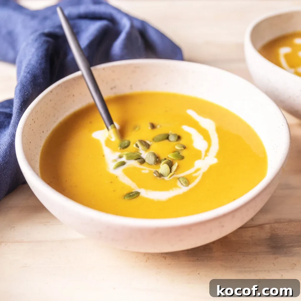 Creamy Butternut Squash and Carrot Soup Recipe for Fall 5 bowl of butternut squash and carrot soup topped with pepitas and coconut milk