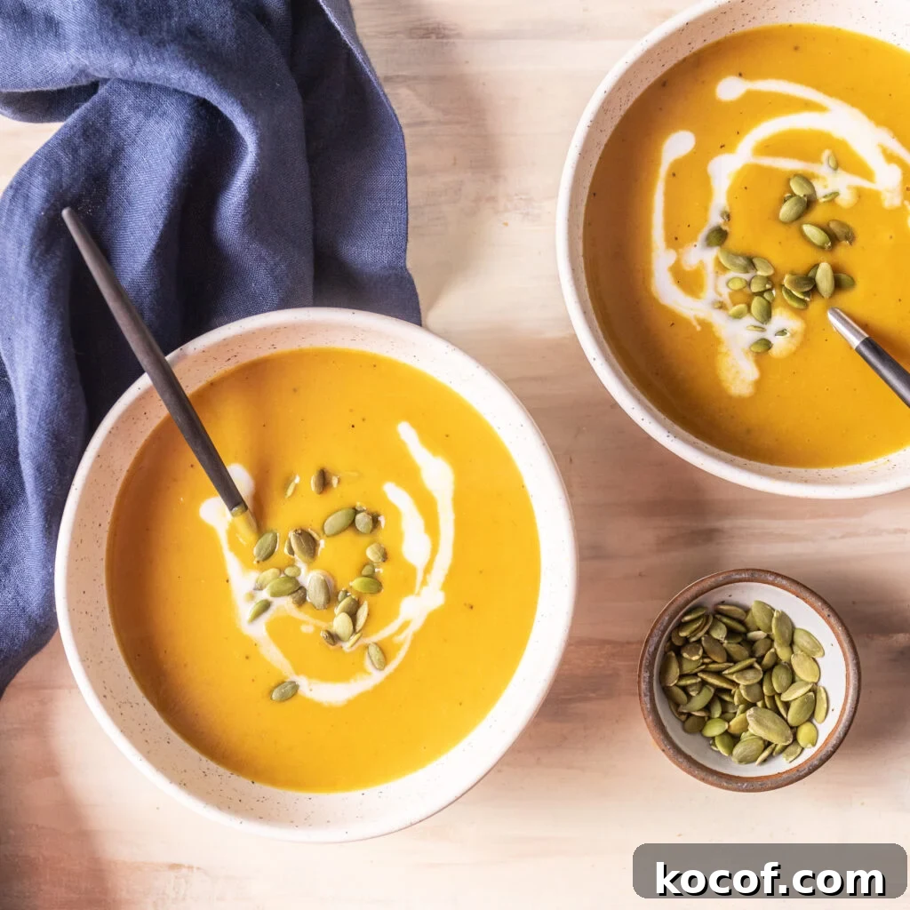 Creamy Butternut Squash and Carrot Soup Recipe for Fall 6 2 bowls of butternut squash and carrot soup topped with pepitas and coconut milk, with a small bowl of pepitas
