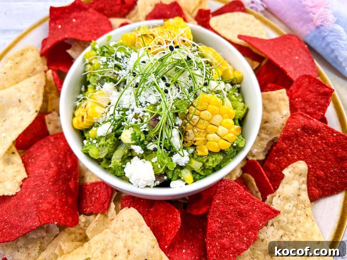 39 Outdoor Grilling Dinners That Make You Ditch the Oven Tonight 24 Corn guacamole with tortilla chips on a plate.