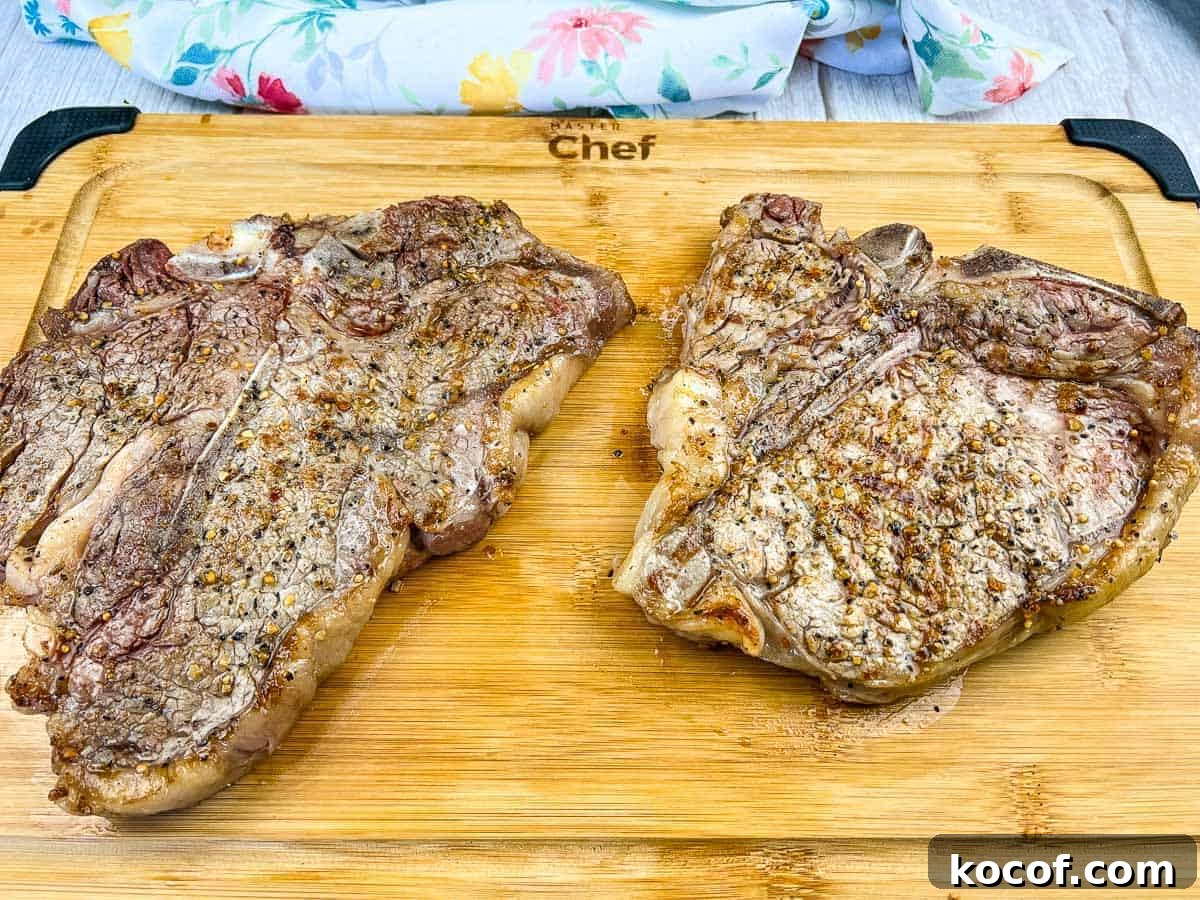 39 Outdoor Grilling Dinners That Make You Ditch the Oven Tonight 28 A grilled t-bone steak on a black platter.