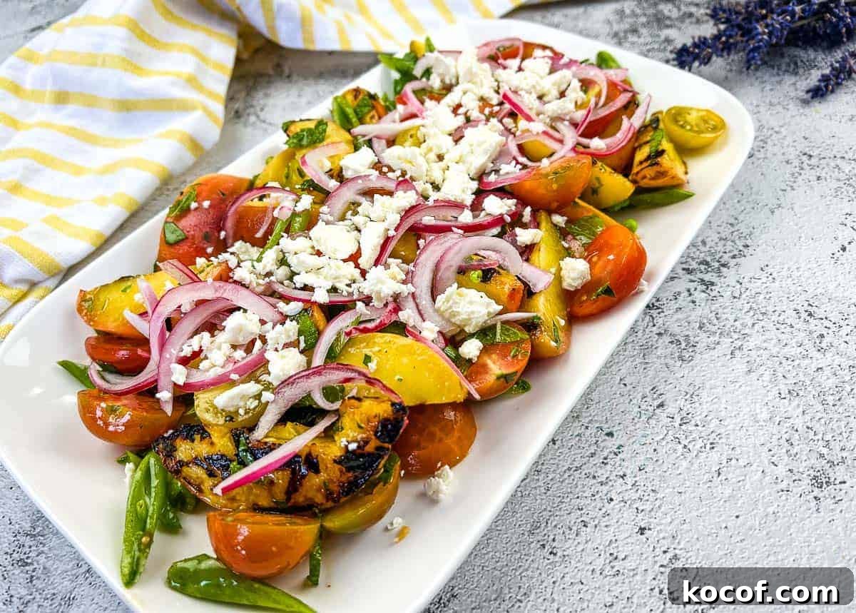 39 Outdoor Grilling Dinners That Make You Ditch the Oven Tonight 29 A plate with Grilled Peach Salad with Tomatoes.