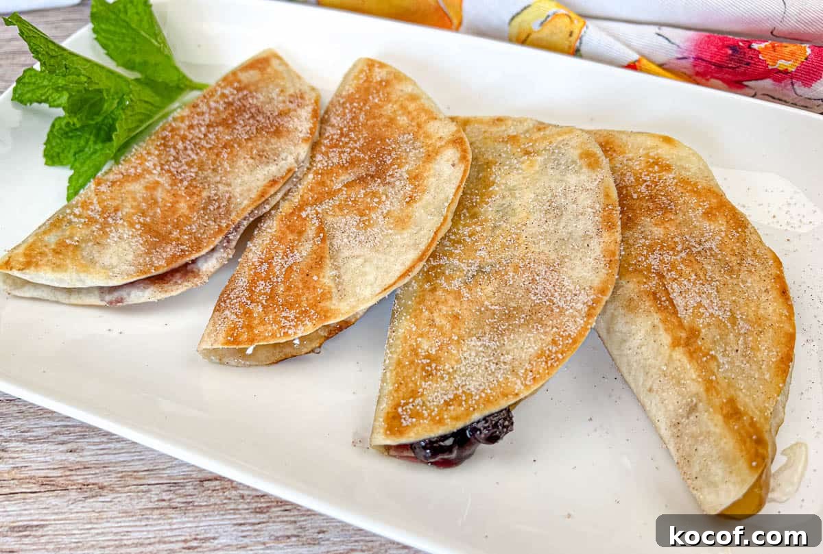 39 Outdoor Grilling Dinners That Make You Ditch the Oven Tonight 4 Four pieces of Fruit Quesadillas on a white plate.