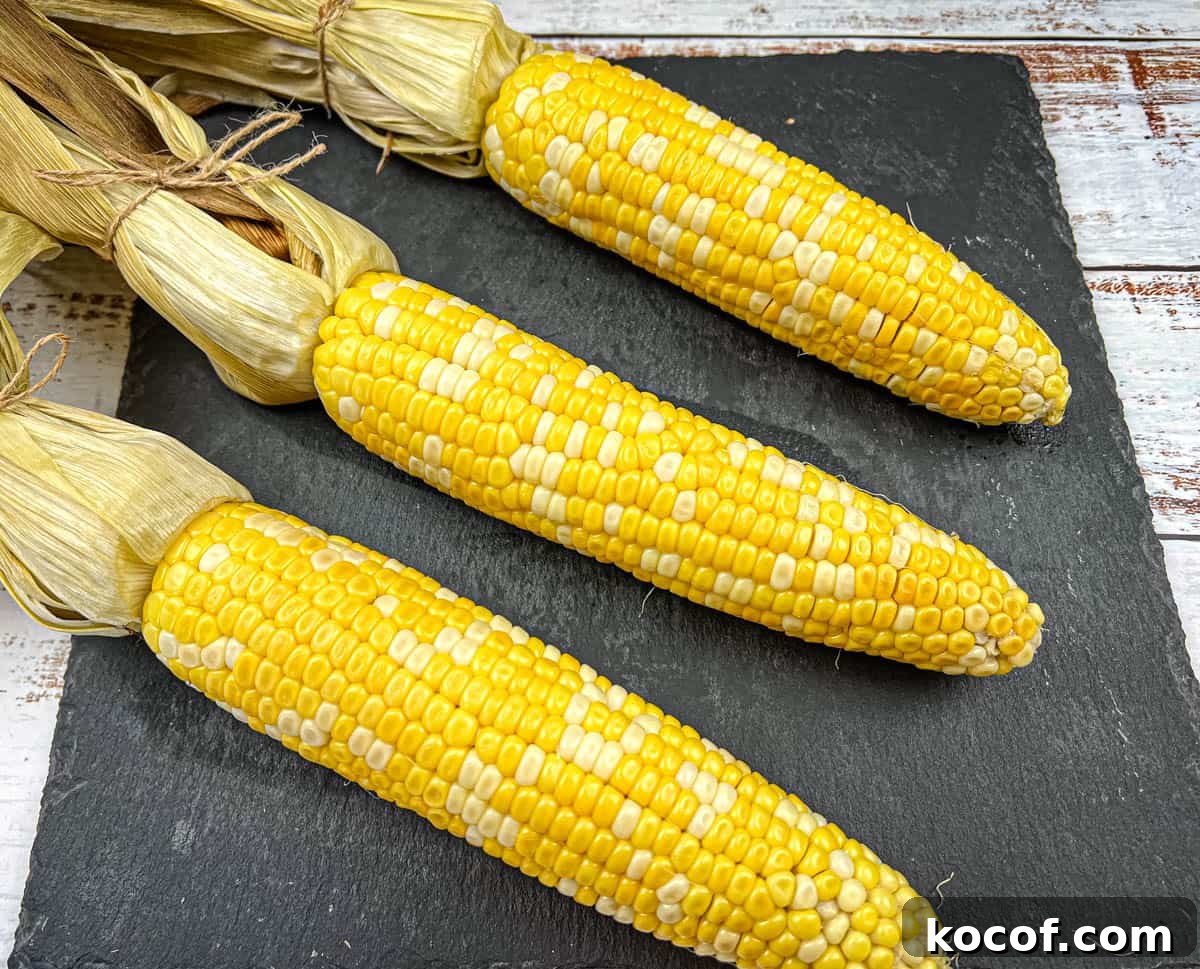39 Outdoor Grilling Dinners That Make You Ditch the Oven Tonight 37 Three ears of husked corn were arranged on a dark slate plate.