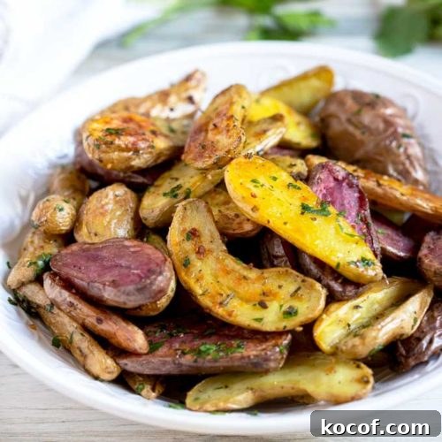 Crispy Roasted Fingerling Potatoes with Garlic and Herbs 4 A bowl of potatoes roasted in the oven in a white bowl