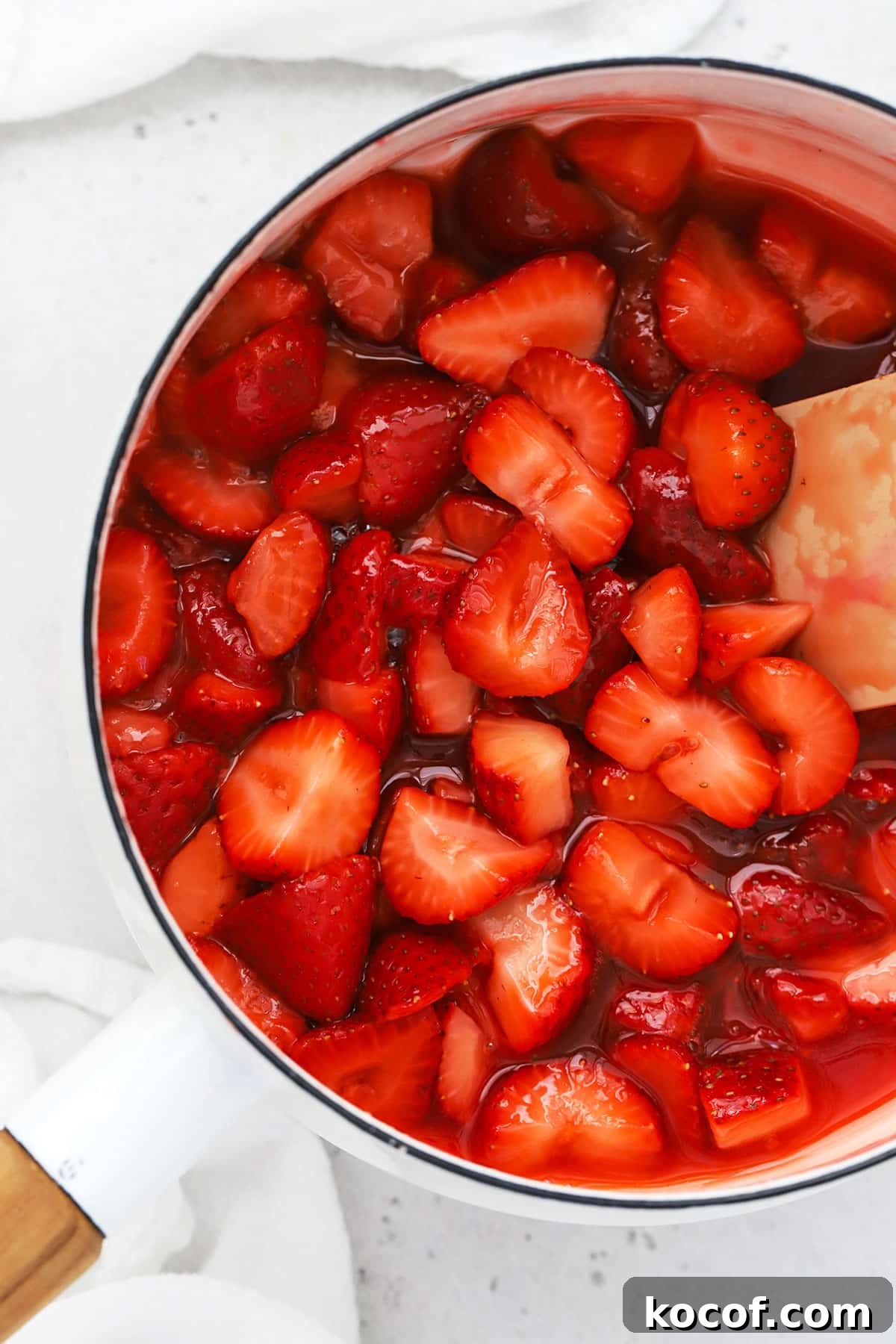Gluten-Free Strawberry Cheesecake Recipe with Fresh Berry Topping 6 thick strawberry sauce in a white saucepan