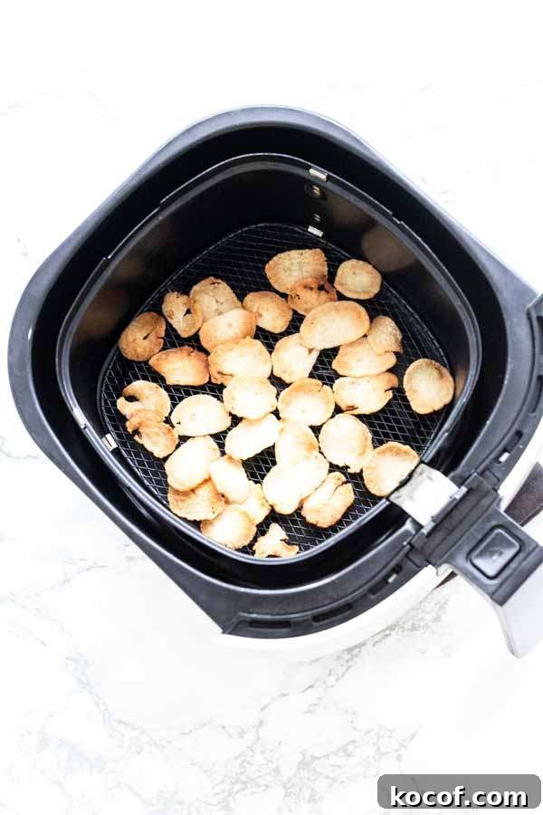 Crispy Air-Fryer Prawn Crackers Recipe for Perfect Crunch 6 Prawn crackers puffed up in an Air Fryer basket