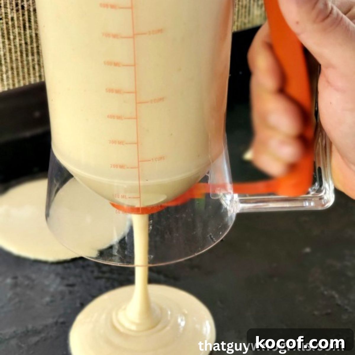 Blacckstone Pancake dispensor pouring batter onto blackstone griddle
