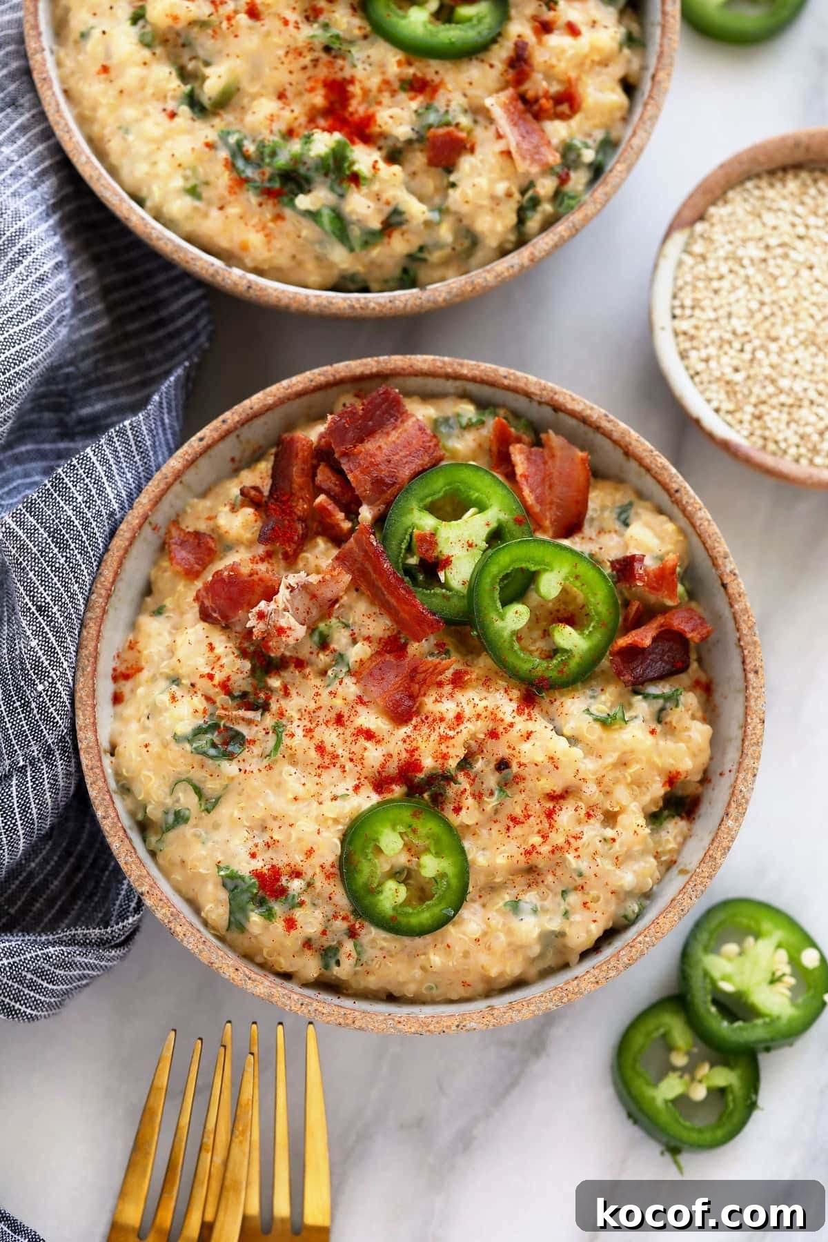 quinoa mac and cheese in a dish topped with jalapenos and bacon