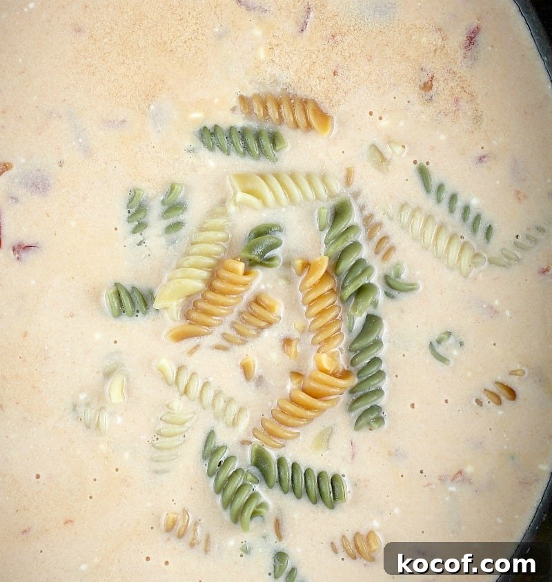top down view of the slow cooker soup showing the pasta added