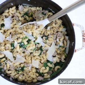 One-Pot Ground Turkey Pasta Skillet Recipe for Quick Dinners 9 Ground Turkey Pasta dish in a white Staub Dutch oven with a white and gold serving spoon.