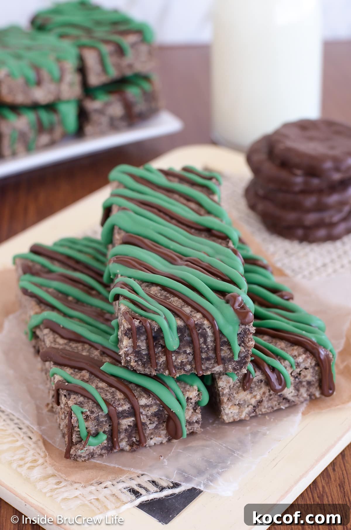 Mint Almond Granola Bars Recipe – Refreshing No-Bake Snack 3 A pile of chocolate granola bars with green chocolate drizzles.