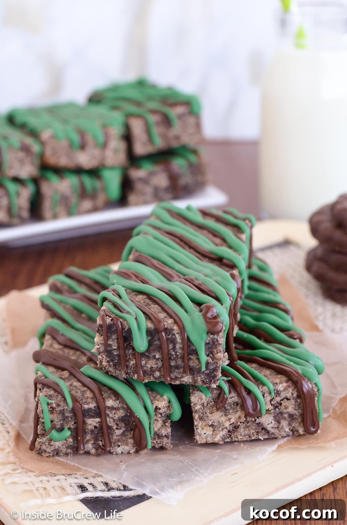 Mint Almond Granola Bars Recipe – Refreshing No-Bake Snack 5 Three granola bars with green chocolate drizzles in a pile.