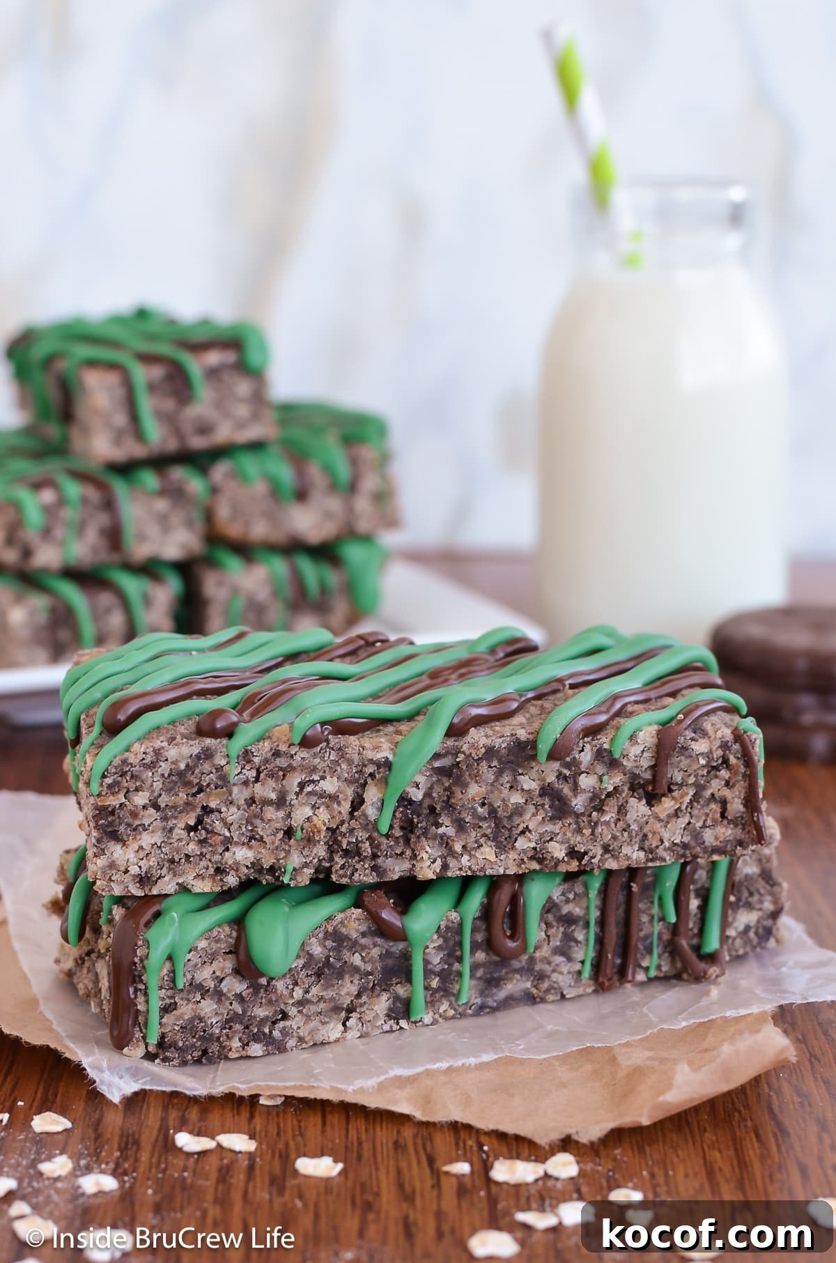 Mint Almond Granola Bars Recipe – Refreshing No-Bake Snack 6 Two mint bars stacked together on a brown board.