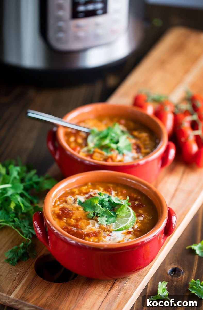 Red Lentil Curry Soup Recipe — Instant Pot and Stovetop Guide 4 Bowls of red lentil curry soup topped with cilantro and lime
