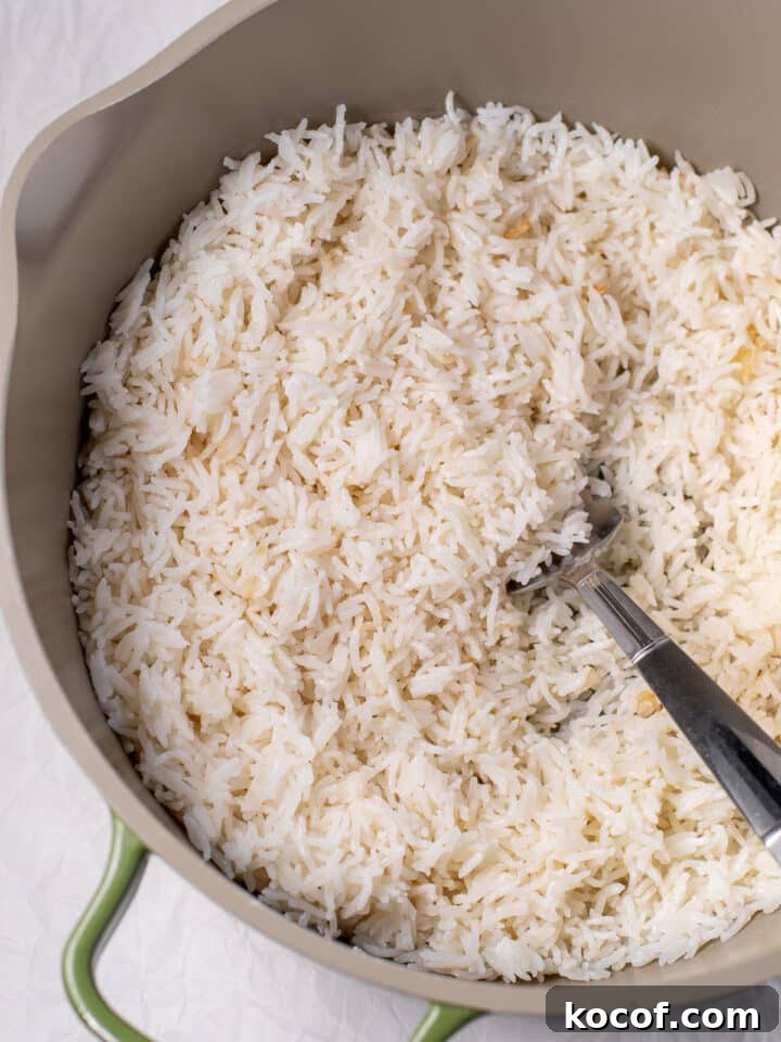 cooked rice in a pot with a large fork