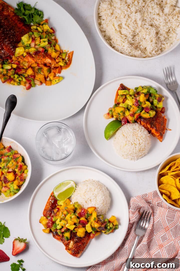 two plates with coconut rice, paprika salmon and nectarine salsa