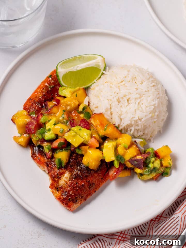 plate with mound of coconut basmati rice, piece of seasoned salmon and dollop of nectarine pico de gallo