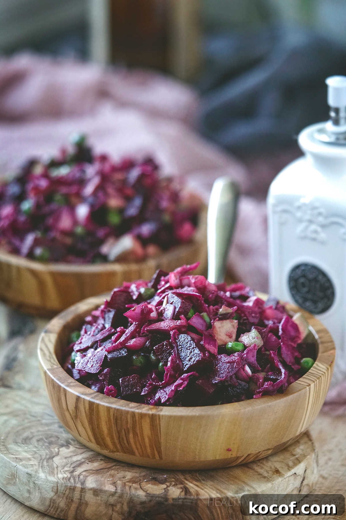 Russian Vinaigrette Salad with Beets and Sauerkraut 3 Russian salad with beets, sauerkraut and peas / Russian vinaigrette salad served in a wooden bowl.