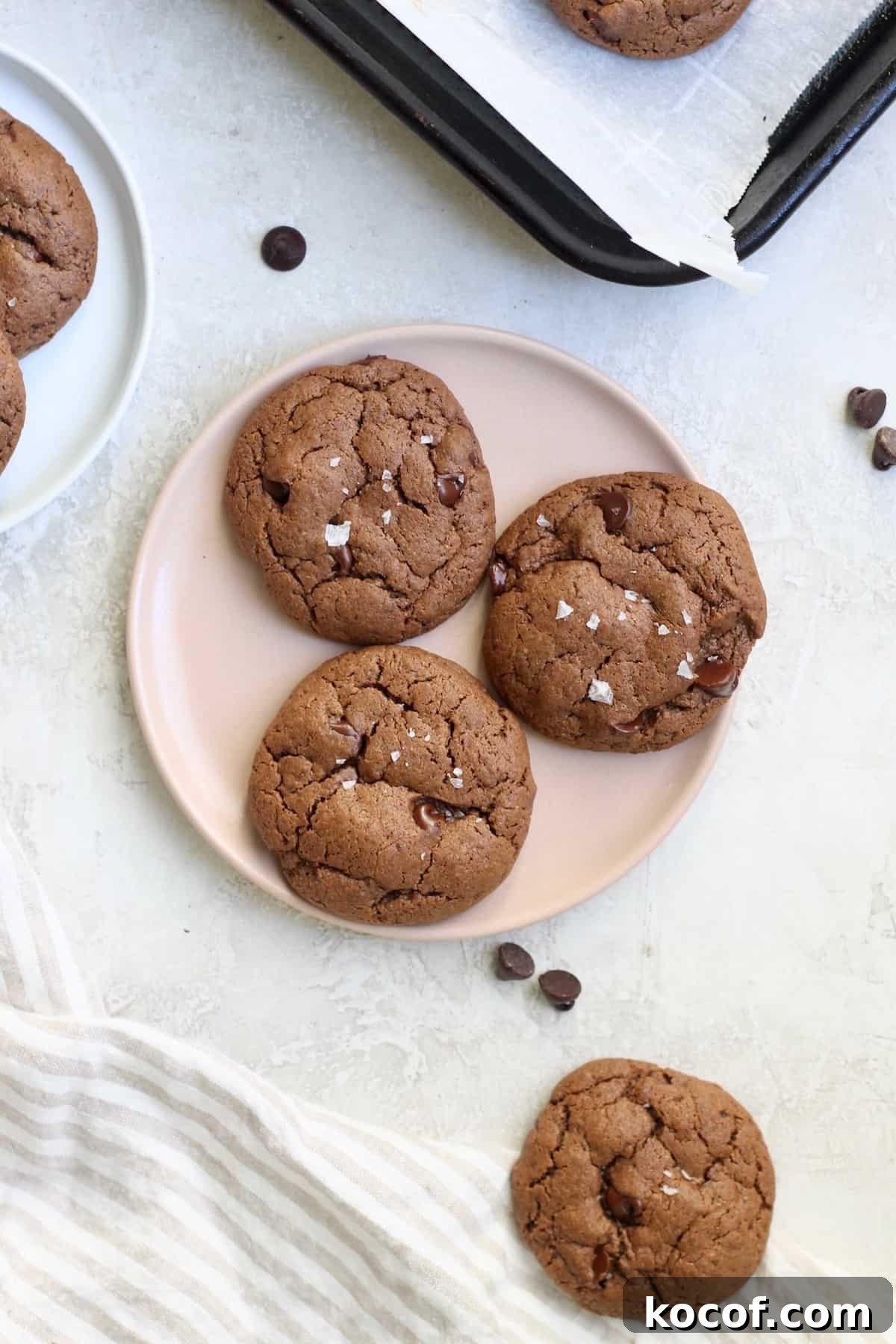 pink plate of three chocolate cookies